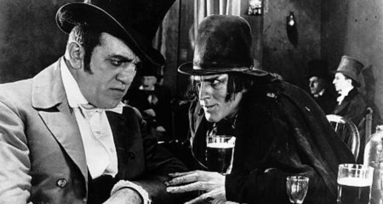 Dr. Jekyll and Mr. Hyde 1920 movie with a dance hall proprietor on the left and Mr. Hyde on the right. It is black and white.