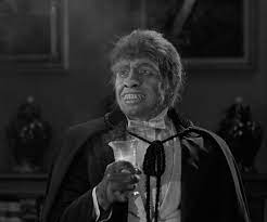 Mr. Hyde from the 1931 Dr. Jekyll and Mr. Hyde movie holding the potion and grinning.