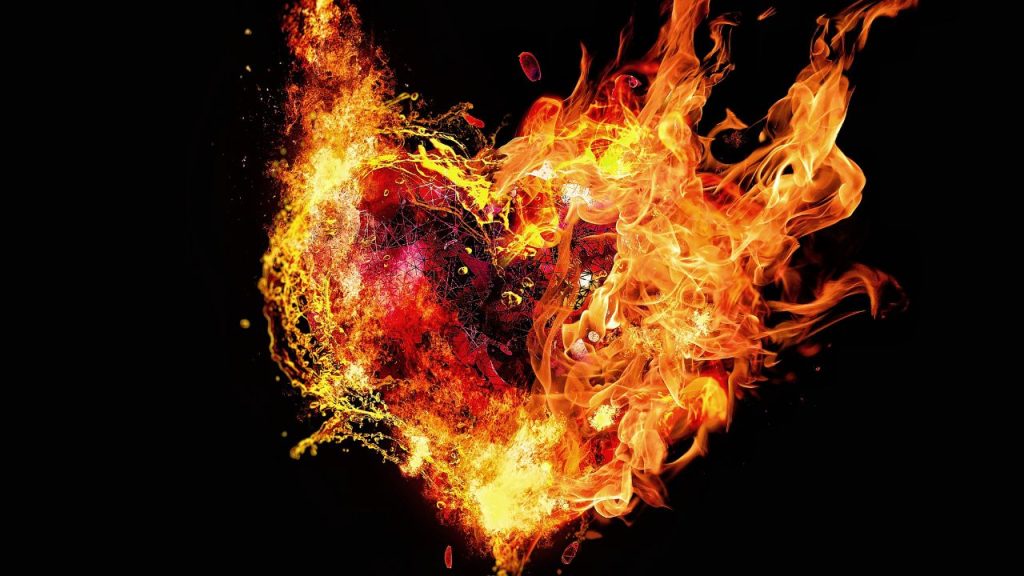 Red and black heart engulfed on flames on a black background