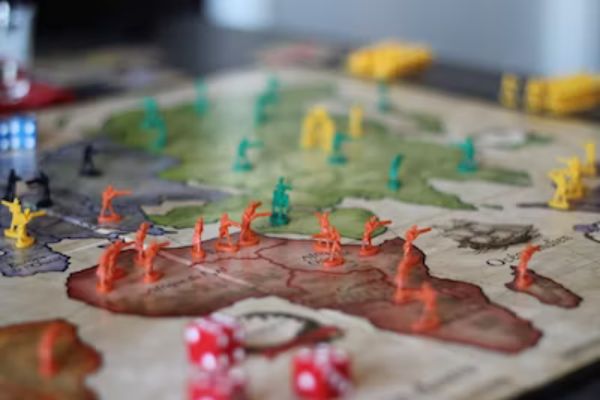 Strategy game board with armies of various colors and continents.