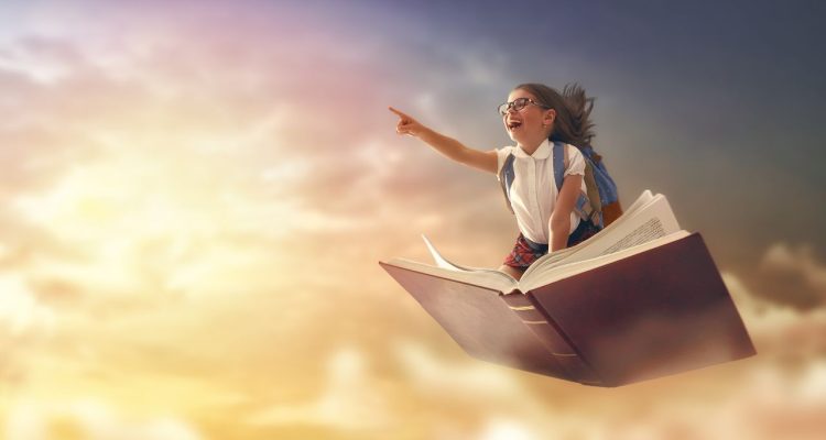 image of girl flying on a book pointing at the sky.