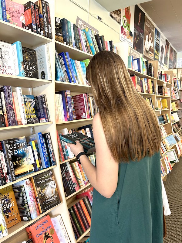 Sydney Wright browsing the bookshelves in Bookends