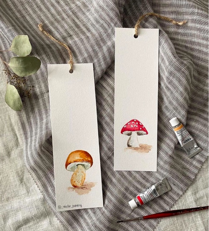 two bookmarks painted with watercolor mushrooms.