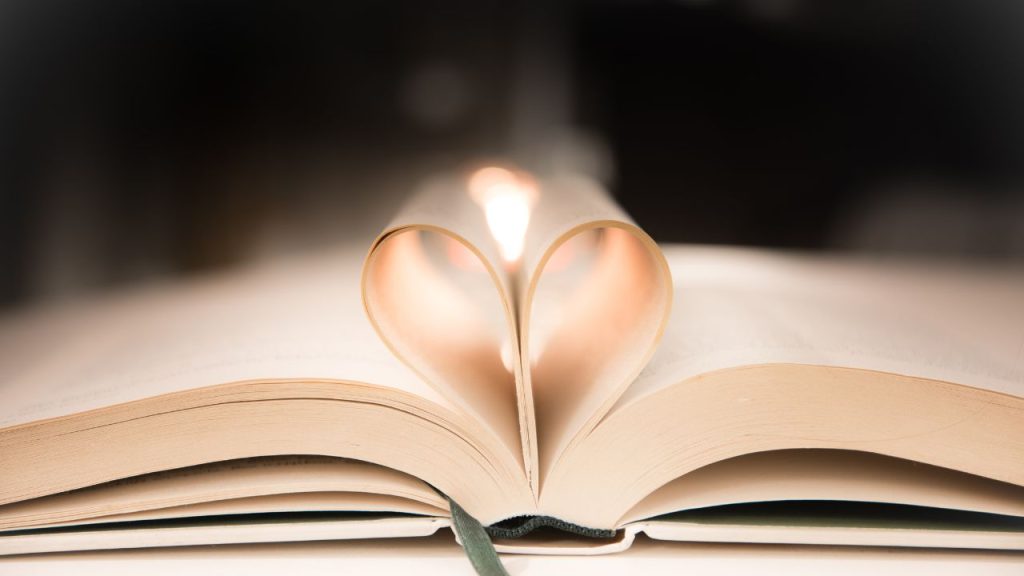 The pages of a book folded into the center of the book to make a heart.