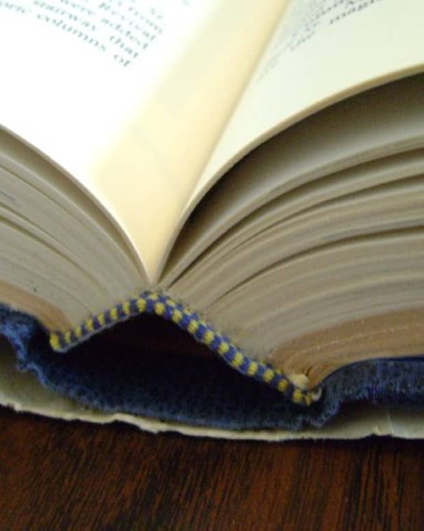 hardcover book cracked open with a broken blue spine