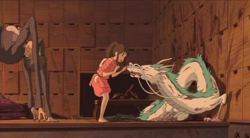 Chihiro hovering over a bloodied dragon Haku with Kamaji on the side