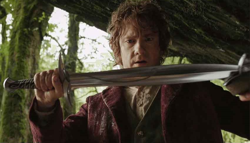 Bilbo Baggins staring at his sword Sting held carefully in his hands