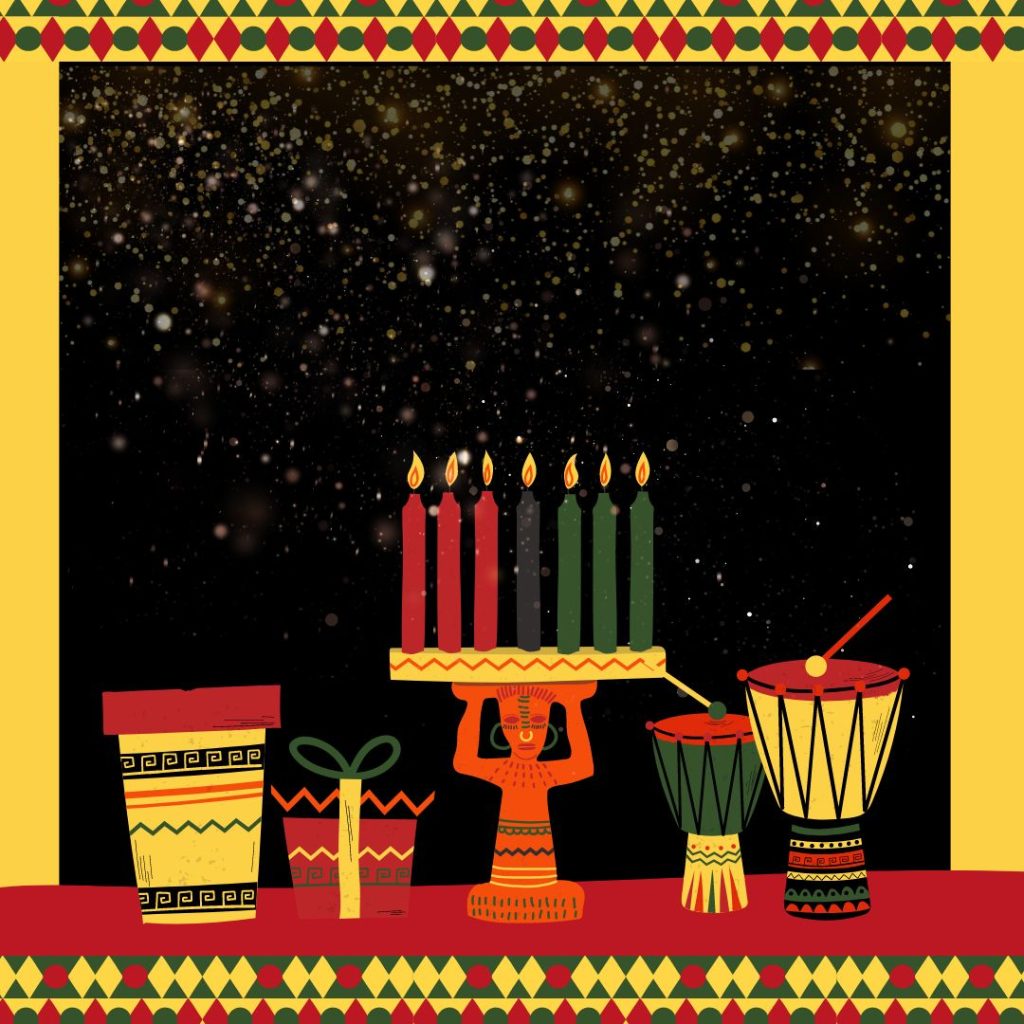 A yellow, red, and black setting with a patterned border of red, green, and yellow. A decorative candleholder made of a person holding up the seven candles. The candles are red, black, and green. Drums and presents sit on either side of the candleholder. Everything sits on top of a red surface.