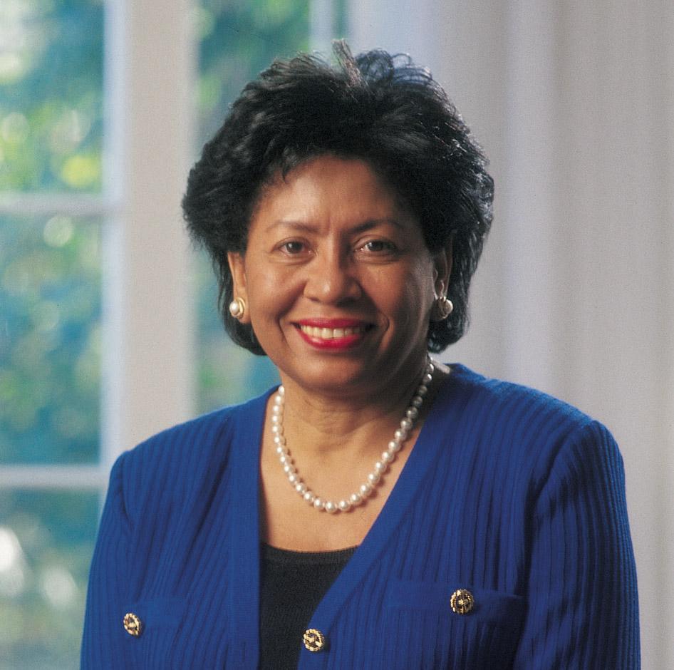 Ruth J. Simmons wearing a blue sweater and smiling.