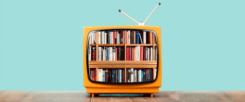 A yellow TV filled with books instead of a screen