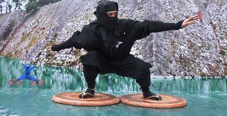 A ninja wearing full black garb standing on water devices called mizugumo to stand on water
