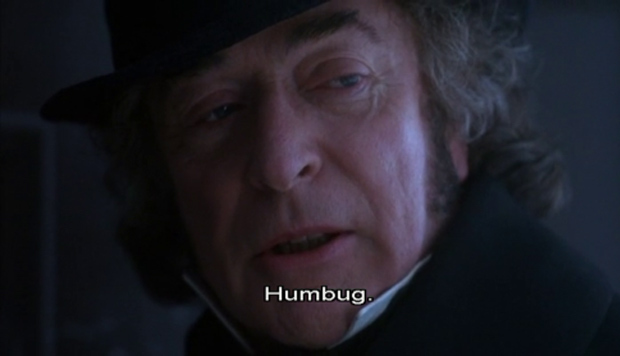 Headshot of Scrooge looking grumpy with the caption saying "Humbug."