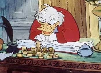 Ebenezer Scrooge counting money on his desk