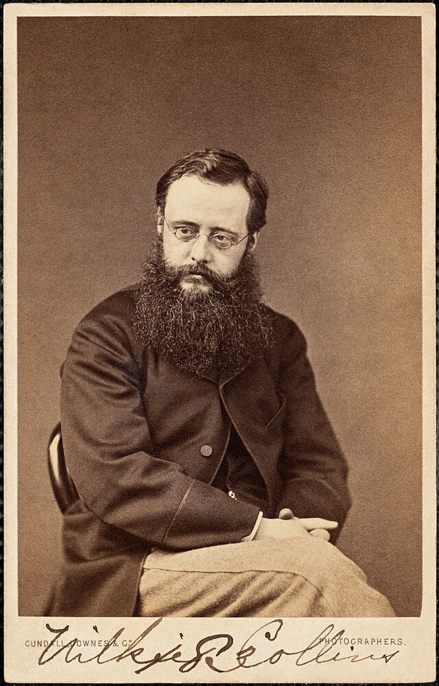 Tintype of author Wilkie Collins. He sits in a chair and stares to the left of the camera. Includes Wilkie's signature