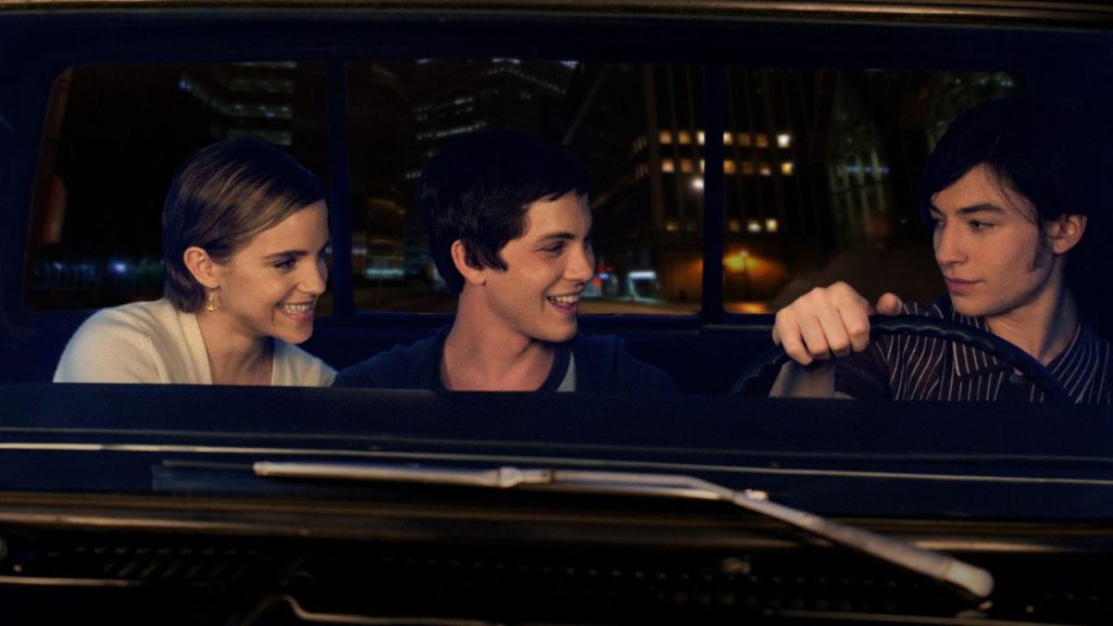 photo of Charlie, Sam, and Patrick sitting in the car and driving through the city