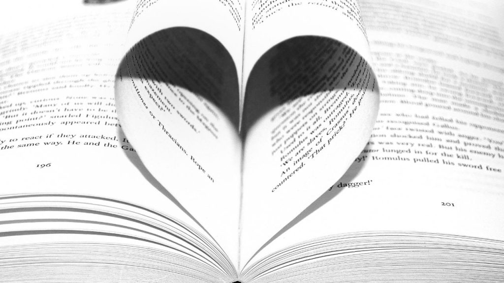 open book with two pages bend to look like a heart