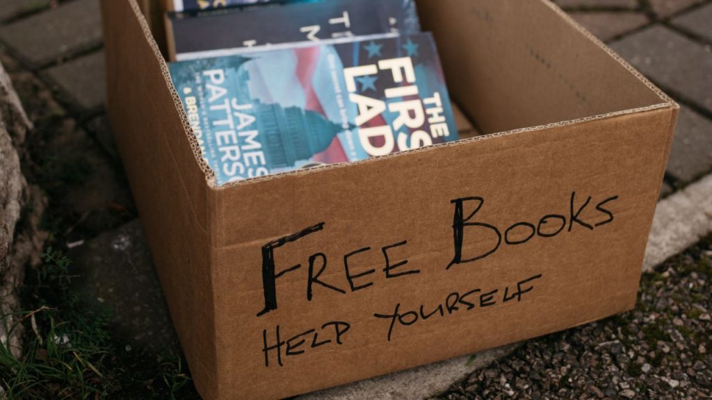 carboard box with books inside labeled Free Books Help Yourself
