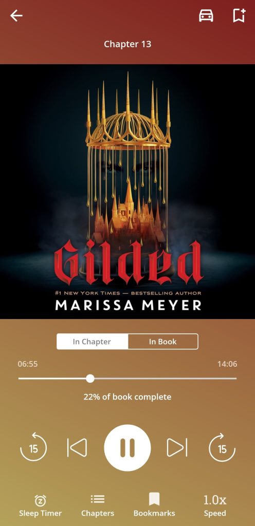 "Gilded" audiobook/"Gilded" in red text across a black background with a golden crown dripping down to create a city. 