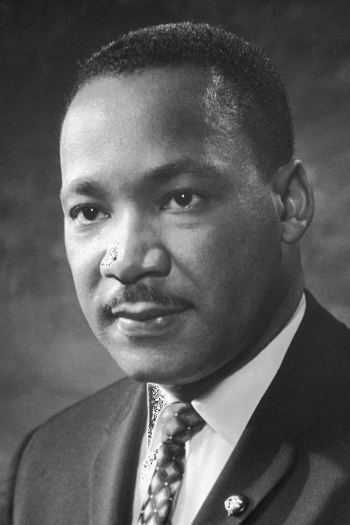 A black and white of Martin Luther King Jr. It is a profile picture of him dressed in a suit.