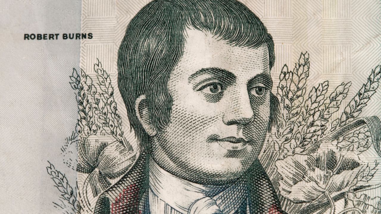 Drawing of Robert Burns in a red coat with flowers behind his shoulder. The name Robert Burns is printed to the left of the page.