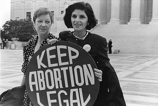 Norma McCovey and Gloria Allred holding a sign that says "Keep abortions legal."