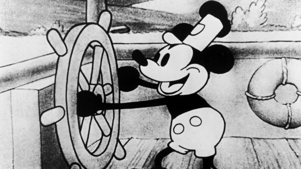 Steamboat Willie smiling while steering a boat. 