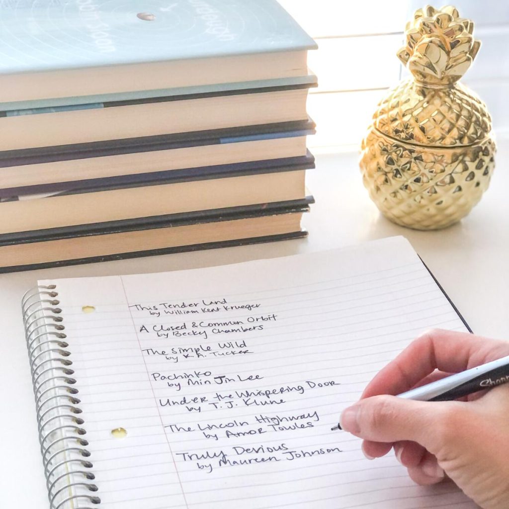 unknown person writing on a notebook