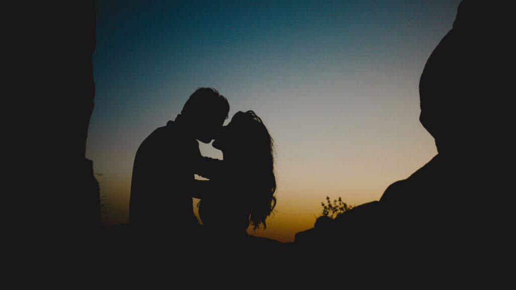 A couple kissing at sundown