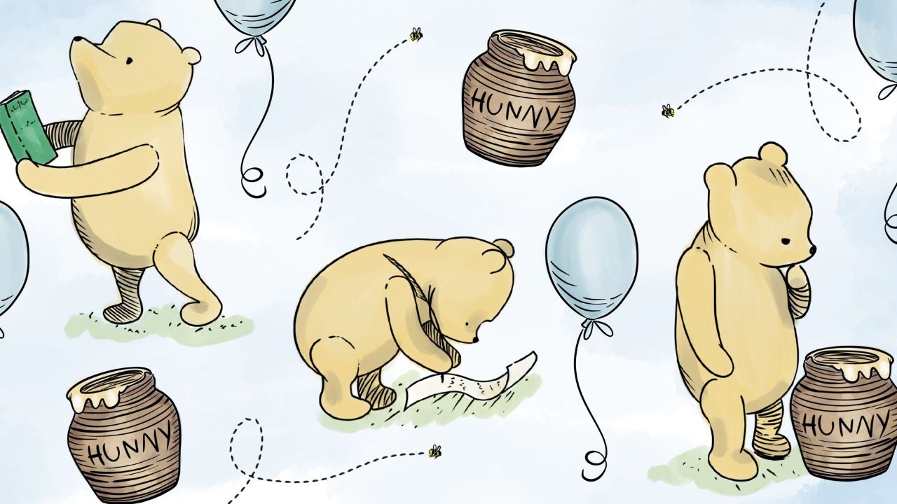 A yellow bear surrounded by blue balloons and honey pots.