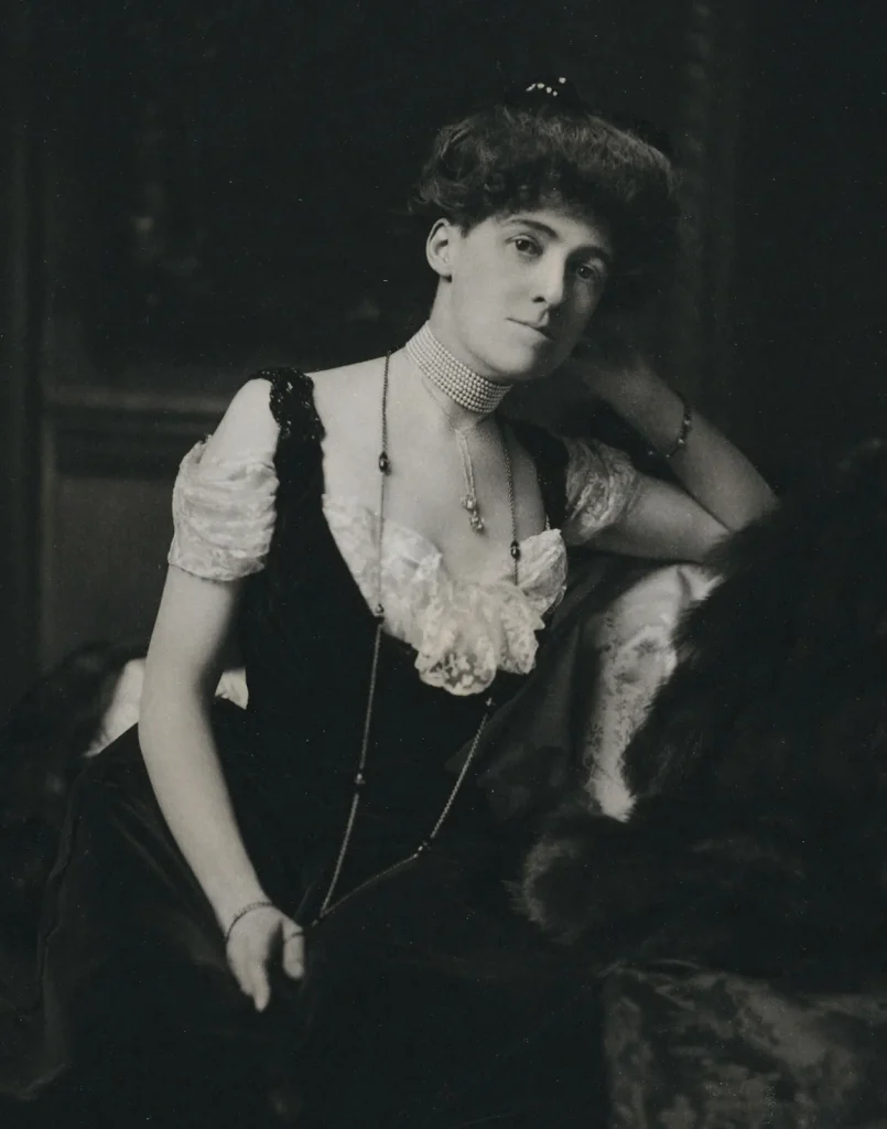 Edith Wharton in a black dress with her hair up.