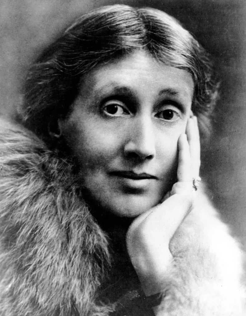 Virginia Woolf looking at the camera while wearing a fur coat.