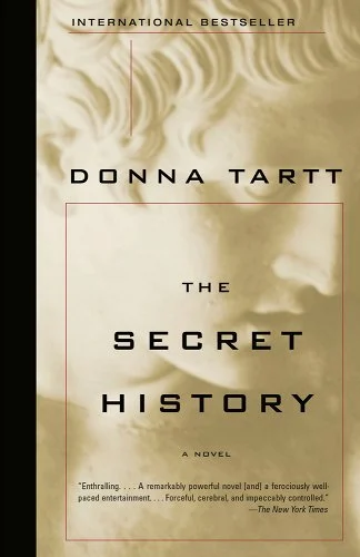 The Secret History by Donna Tartt, a book with a sculpture's face in the background.