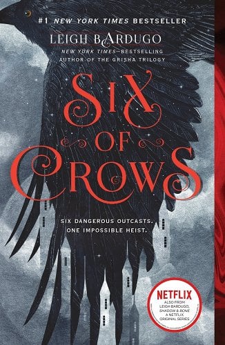 Six Of Crows by Leigh Bardugo, a book with a crow spreading its wings in midflight and a kingdom behind it.