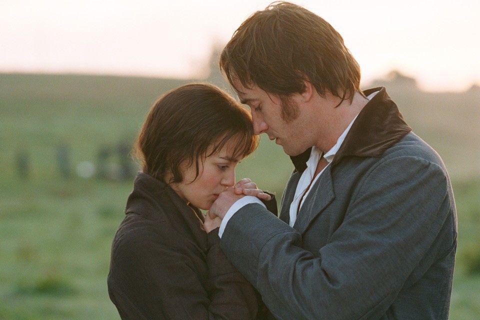Elizabeth Bennet holding and kissing Darcy's hand.
