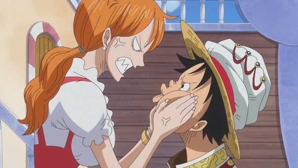 Nami angirly squishing Luffy's cheeks while they glare at each other.