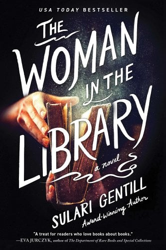 "The Woman in the Library" is written in white across the cover. A book is opened by two hands in the center of the image as dust flys from between the pages.