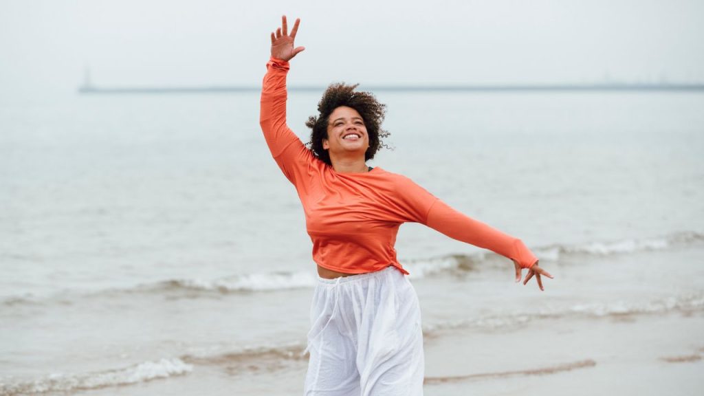 woman dancing on the beach