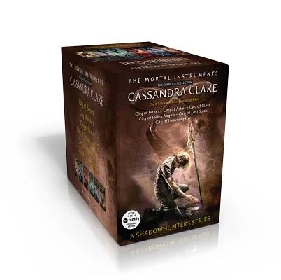 The Mortal Instruments boxed set with a blonde man kneeling on the ground on the cover.