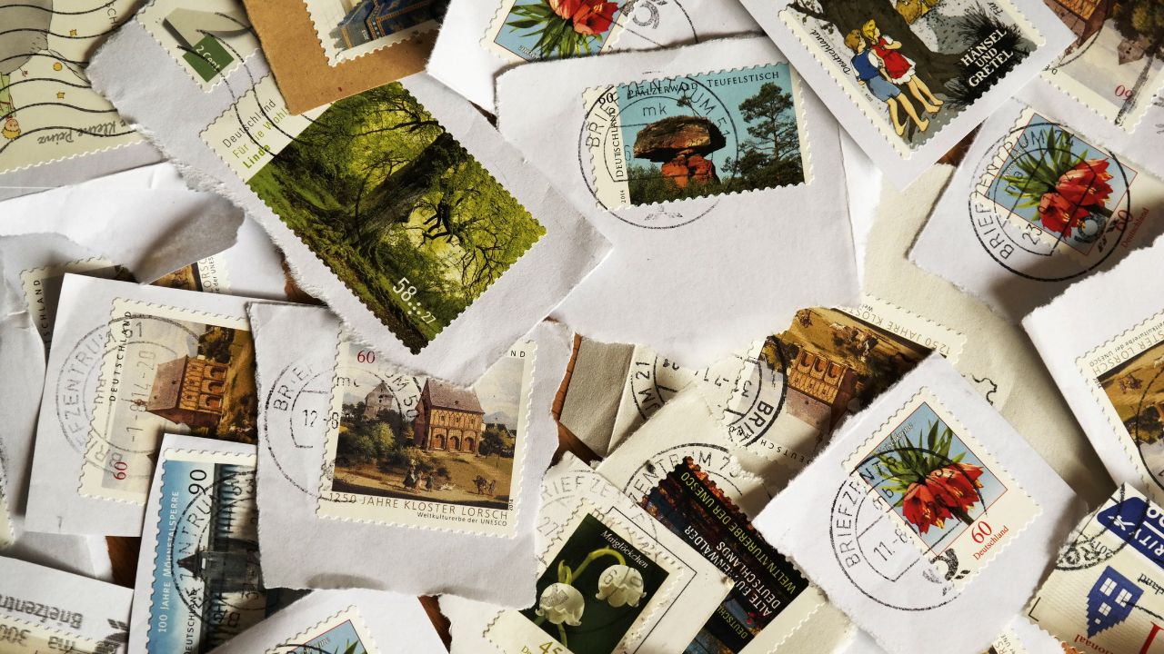 A scattered collage of colorful stamps with different artwork, mostly nature-themed.