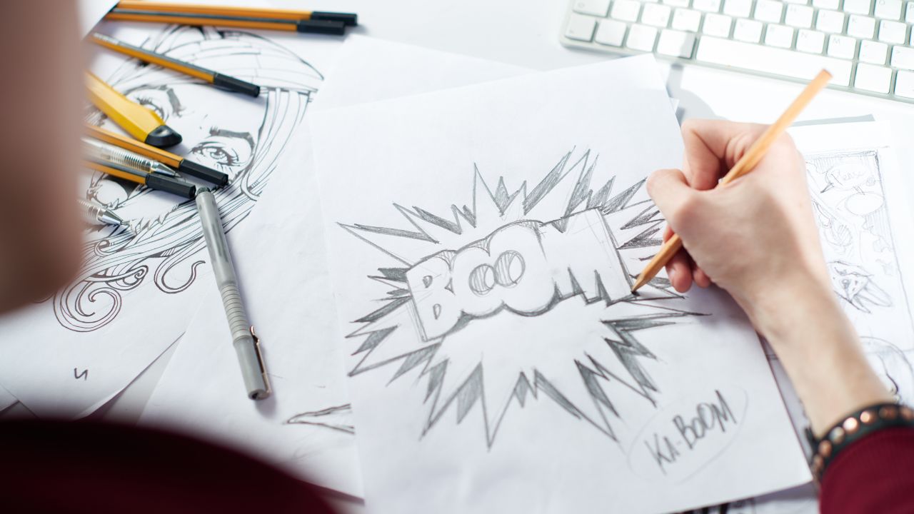 person drawing comic book explosion with capitalized boom in the center.