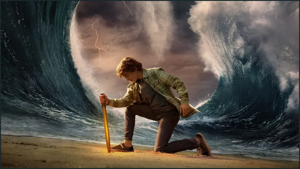 Percy Jackson from the TV show wearing a green flannel and jeans and stabbing a gold sword into the sand. 