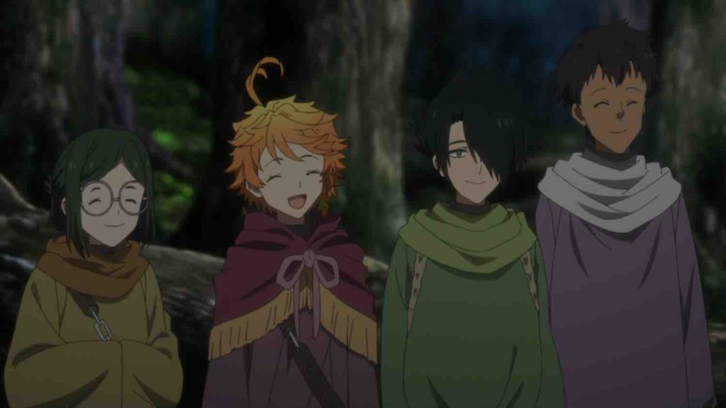 Gilda, Emma, Ray, and Don standing next to each other wearing colorful cloaks.