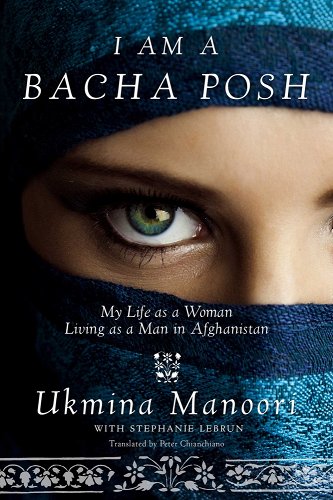 Close up of a person's face wearing a rich two-toned blue headdress covering everything except the eyes. The eyes are a pretty greenish color. Across the top it says in white lettering: I am a bacha posh. Below her eyes, in smaller white text, it says: My life as a woman living as a man in Afghanistan. Below that in larger lettering is the authors name: Ukmina Manoori. Below that in smaller lettering it says: with Stephanie Lebrun translated by Peter. Finally, across the bottom is a strip of white flowered filigree.