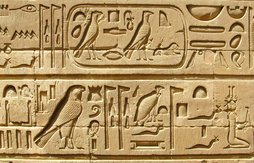 Ancient Egyptian hieroglyphics carved into stone.