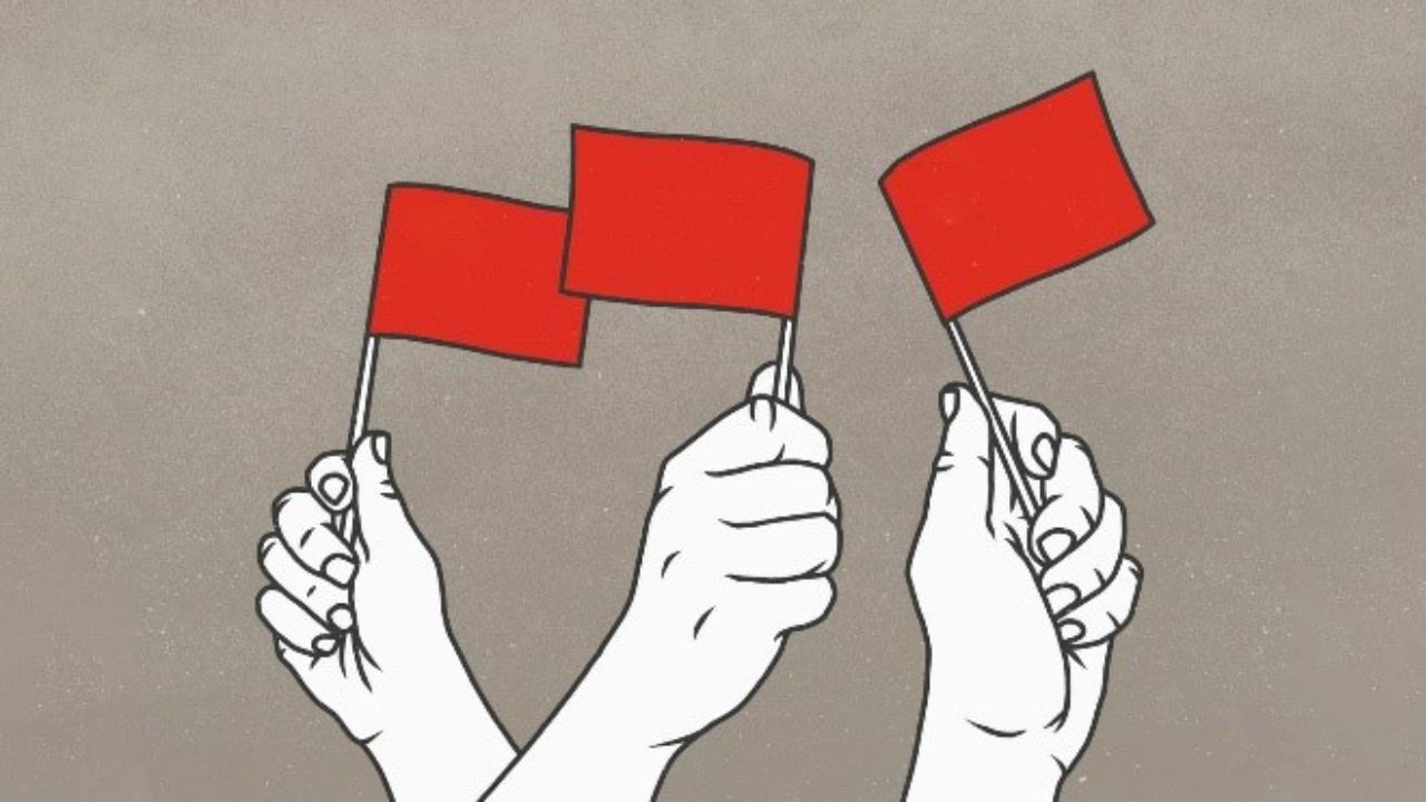3 white hands waving small red flags on a gray background