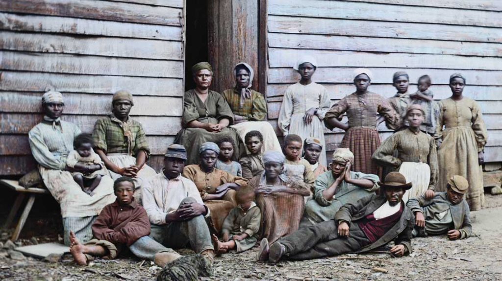 A colorized image of slaves in a slavehouse in America.