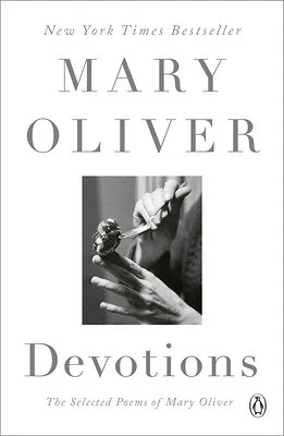 Mary Oliver's Devotions cover with a woman holding a spoon in a black and white photograph.