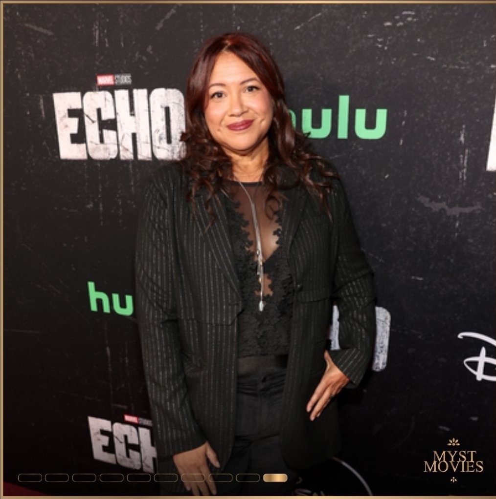Rebecca Roanhorse at an awards show with Marvel Studios' 'Echo' and Hulu logos behind her.