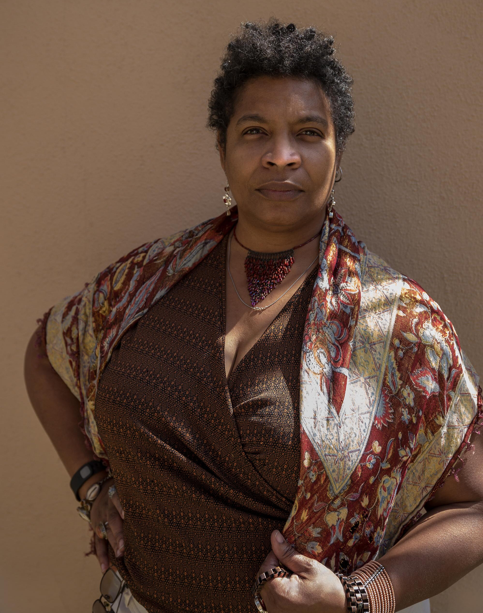 Nalo Hopkinson staring at camera with her hands on her hips.