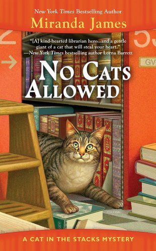 A tabby cat is posed in front of a bookshelf near a foot stool and a stack of books. The surrounding shelves are a burnt orange color.